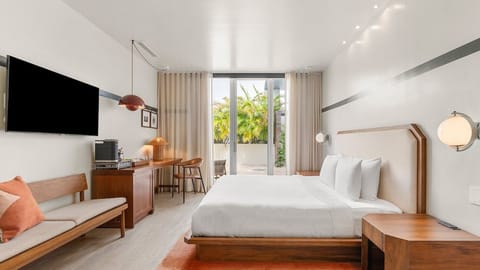 Unwind in a bright king room with breezy terrace views.