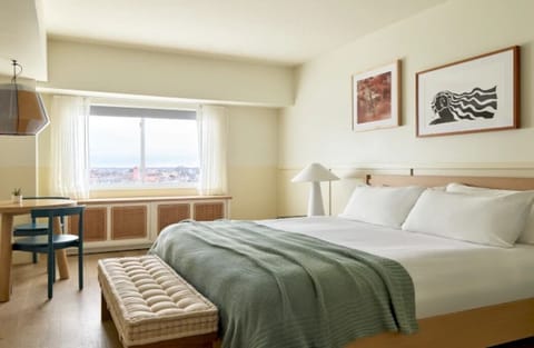 Wake up to soft daylight and a calming city view.