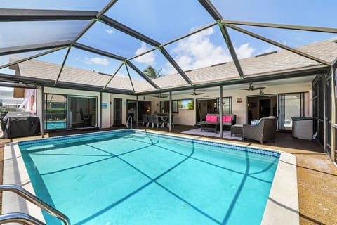 Large, heated pool area with outdoor living and dining spaces.