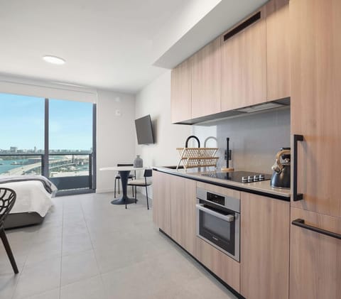 Modern full kitchen with ample storage and city views
