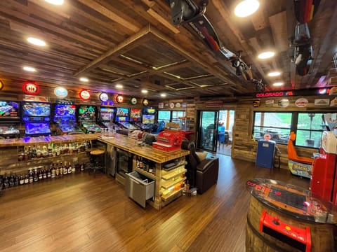Epic game room with 120” motorized theater screen, Sonos surround, RGB star ceil