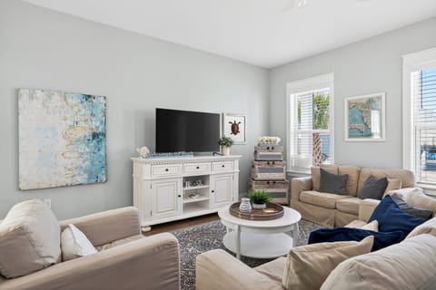 Bright, beach‑inspired lounge with soft neutrals and ocean‑blue accents.