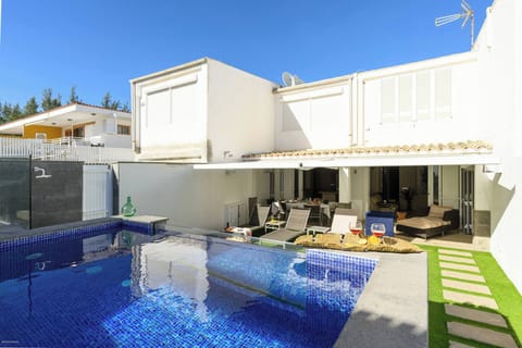 Outdoor area with private swimming pool and sun loungers, ideal for relaxing