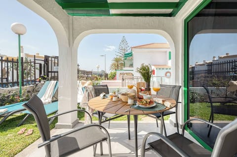 Private porch with table, chairs, and sun loungers, perfect for enjoying the outdoors and relaxing