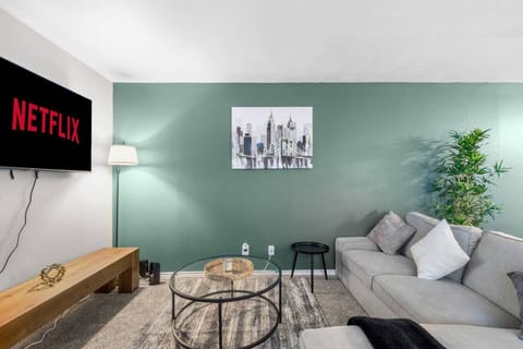 Spacious and inviting living area with comfortable seating and a smart TV, perfect for relaxing after exploring Arlington or attending events at AT&T Stadium.