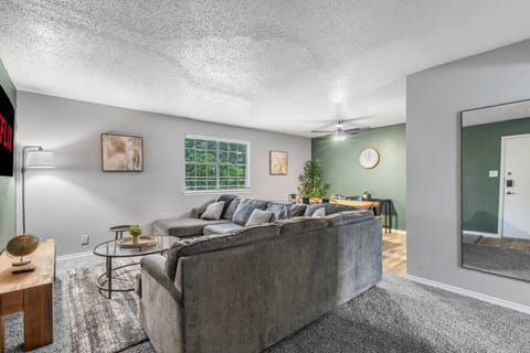 Spacious and inviting living area with comfortable seating and a smart TV, perfect for relaxing after exploring Arlington or attending events at AT&T Stadium.