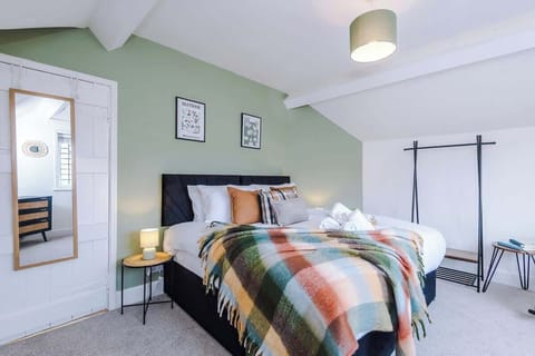 A comfortable bedroom with a king-size bed that can be easily separated into two single beds. The room has soft lighting, cozy bedding, and a calm atmosphere for a relaxing stay
