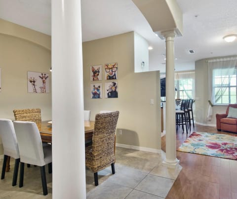Open-plan living and dining area with cozy seating and colorful decor.
