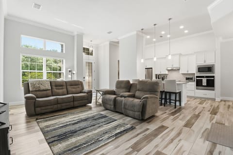 Open Living Area | Reclining Seating & Breakfast Bar | Modern Kitchen