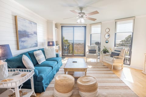 “Coastal‑bright living room with ocean views, soft blues, and breezy, sun‑filled comfort.
