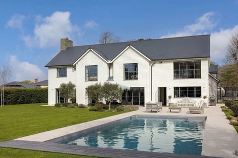 Stunning coastal retreat with heated pool and landscaped gardens, perfectly set near Chichester Harbour.