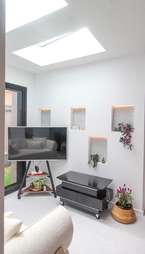 Living space with ambient feature wall and king sofa bed positioned for comforta