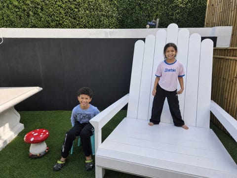 Playful family-friendly patio with giant chair and photo-worthy charm