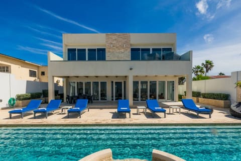 Relax by the sparkling pool, enjoy sun-filled days on the lounge chairs, and unwind in the comfort of this modern villa. Perfectly situated for an unforgettable vacation experience.