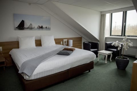 Wake up bright and cozy beside the peaceful window view.
