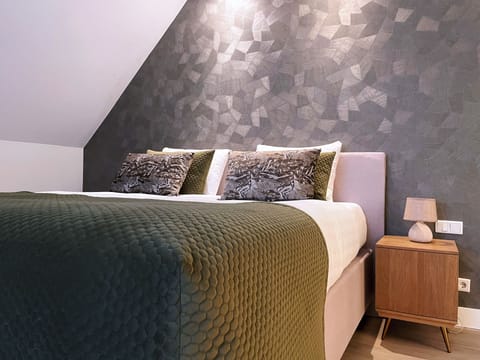 Unwind in a stylish bedroom with plush, cozy bedding.