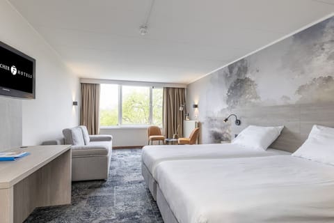 Stretch out in a spacious room with sofa and serene views.