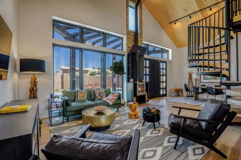Unwind in your stylish living space with soaring ceilings, cozy fireplace, and vibrant Southwest décor that creates the perfect retreat.