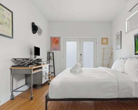 French glass doors and high windows flood the bedroom with natural light while keeping your privacy.