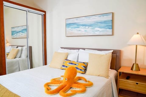 Relax in this cozy bedroom with a comfortable queen bed, soft linens, and calming coastal décor. Perfect for a restful night after a day at the beach.