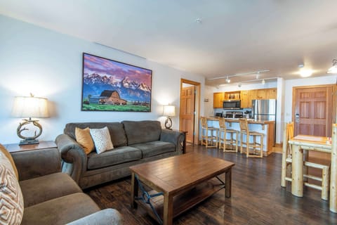 Open living area with fireplace, dining table, and breakfast bar