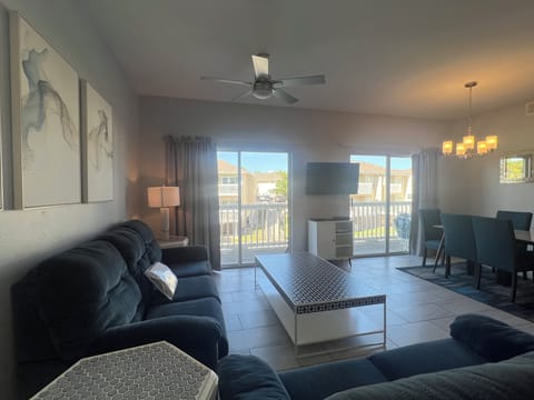 Settle into your spacious living room with plush seating and modern touches, where natural light flows through sliding doors to your private balcony.