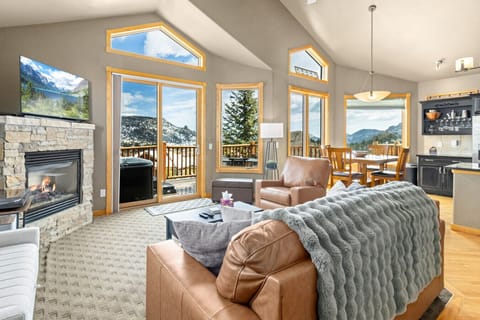 Comfortable living room with warm fireplace and views
