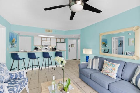 Coastal living room with breakfast bar seating and tropical Key West colors.