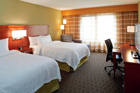 Recharge comfortably with two cozy beds and a work desk.