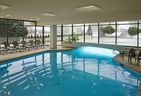 Dive into the sunlit indoor pool with skyline views.