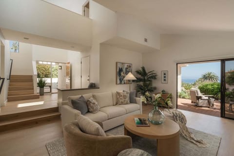 The volume ceilings add drama to a bright and cheerful living room.