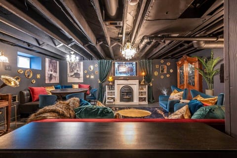 Speakeasy Lounge, game room with moody decor, poker table, electric darts, board games and more