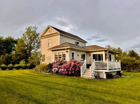 Beautiful seasonal blooms and lush greenery enhance the home’s inviting outdoor atmosphere.