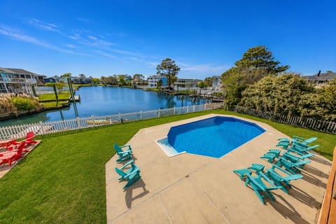 Enjoy poolside views of the Back Bay from your spacious waterfront retreat