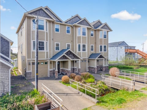 Modern coastal property with stone accents and thoughtful landscaping in a charming beachside neighborhood.