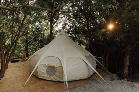The glamping tent is tucked away in the back of 13 acres. It's is entirely private and yours to enjoy.