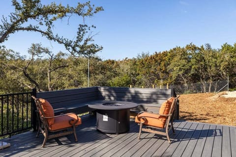 Expansive deck with a built-in fire pit. Surrounded by nature, this area is furnished with rustic wooden benches and chairs, creating an ideal spot for evening gatherings or peaceful solitary moments.