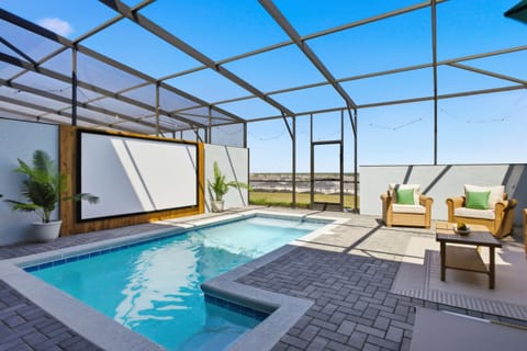 Spacious patio with dining, pool, and entertainment space