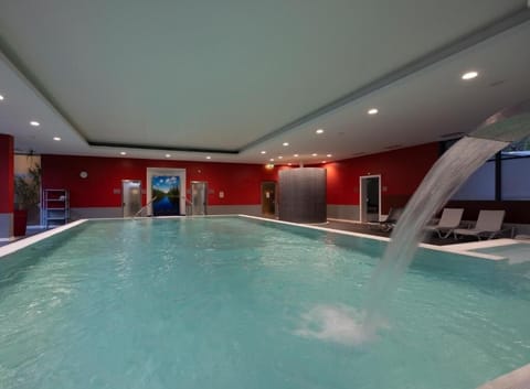 Indulge under the cascading waterfall for a spa-like soak.