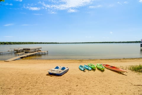 Sandy beach with kayaks and a paddle boat ready for lake adventures