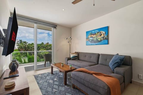 Unwind in a bright, cozy living room with a comfy couch and 55” smart TV. Step onto your private balcony with a slight view of the Akumal sea, and enjoy A/C, a ceiling fan, and room-darkening shades for total comfort.