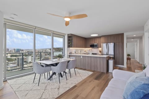 Modern high-rise dining and kitchen with sweeping city views