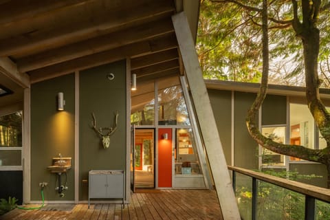 Step onto your private deck surrounded by lush trees, where modern design meets nature's tranquility in this stunning architectural retreat.