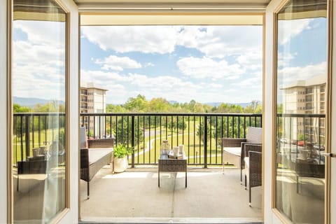 Step onto your private balcony and soak in sweeping views of lush greenery and distant mountains from your comfortable outdoor seating.