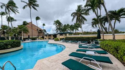 Pool awaits: crystal water, sun loungers, and warm sunshine for your relaxation