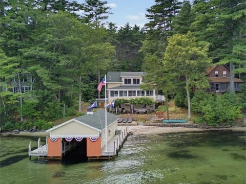 A bird's-eye view of the private dock and boathouse on the water.