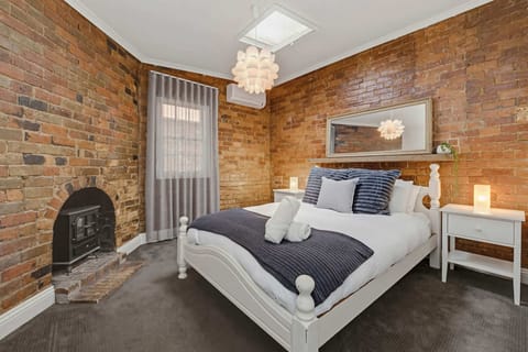 Bedroom 1 - with queen size bed, hanging storage and fireplace. 