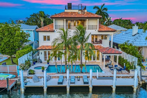 Contemporary family-ready villa with illuminated private pool, hot tub and spacious waterfront dock