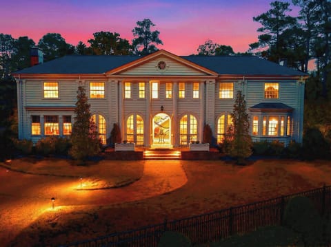 Grand brick estate exterior at twilight