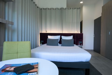 Inviting double bed with modern finishes and soft lighting for a restful stay.